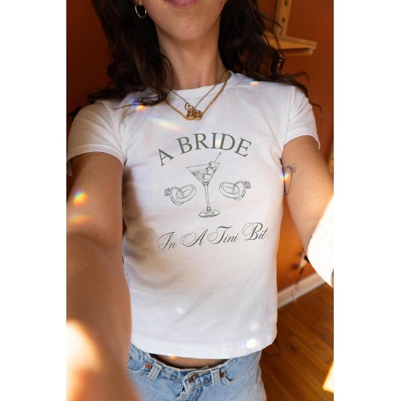 [Sale Up To 20%] A Bride In A Tini Bit Baby Tee, Dirty Martini Themed Bachelorette Party Dirty Martini Bride Baby Tee Casual Comfort